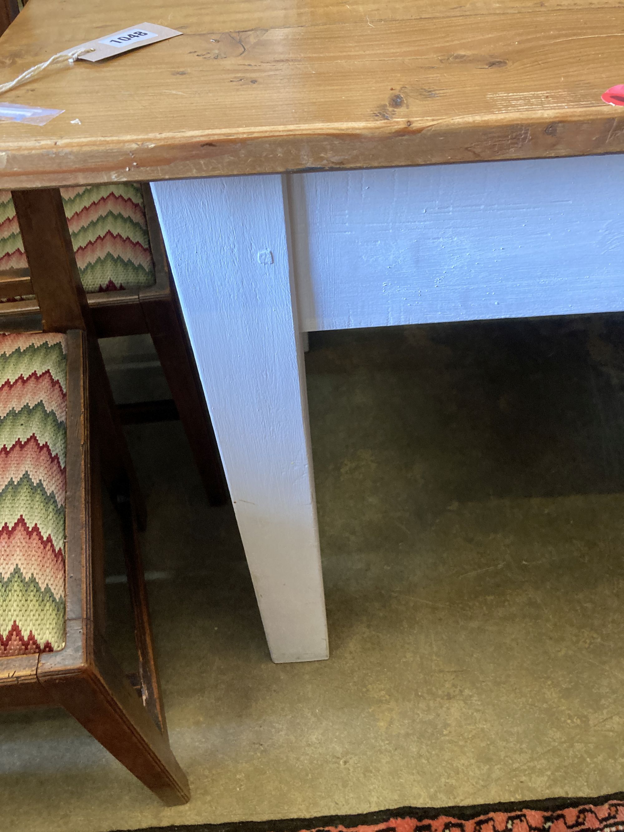 A rectangular pine kitchen table with painted underframe, length 198cm, depth 79cm, height 77cm